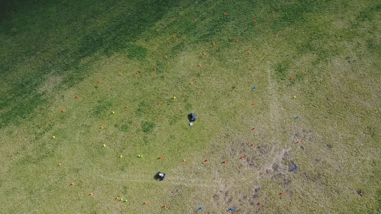 Overhead view of Roboracer R5 on the course marked by cones on grass.